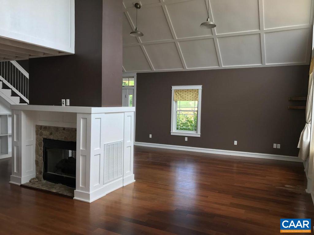 8497 Laurel Road Shipman, VA 22971 - Photo 3 of 37 a view of an empty room with wooden floor and a fireplace