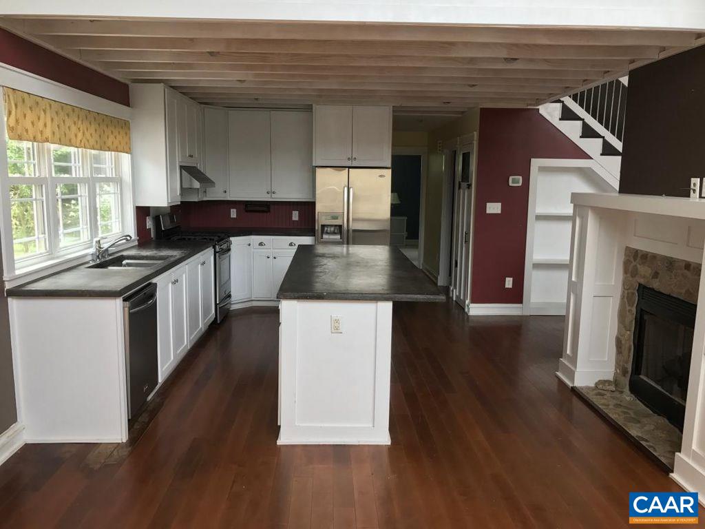 8497 Laurel Road Shipman, VA 22971 - Photo 8 of 37 a kitchen with granite countertop a stove a sink and a microwave