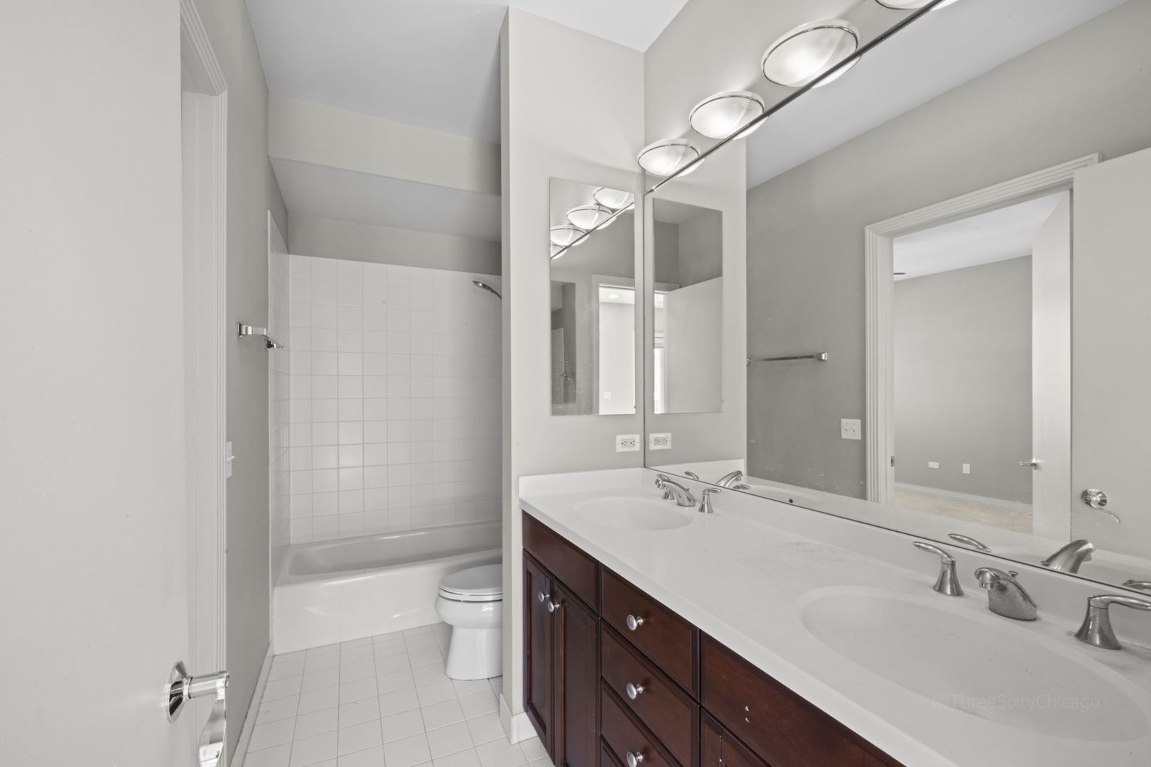 1137 West Monroe Street, Unit 17 Chicago, IL 60607 - Photo 30 of 41 a bathroom with a double vanity sink toilet and shower