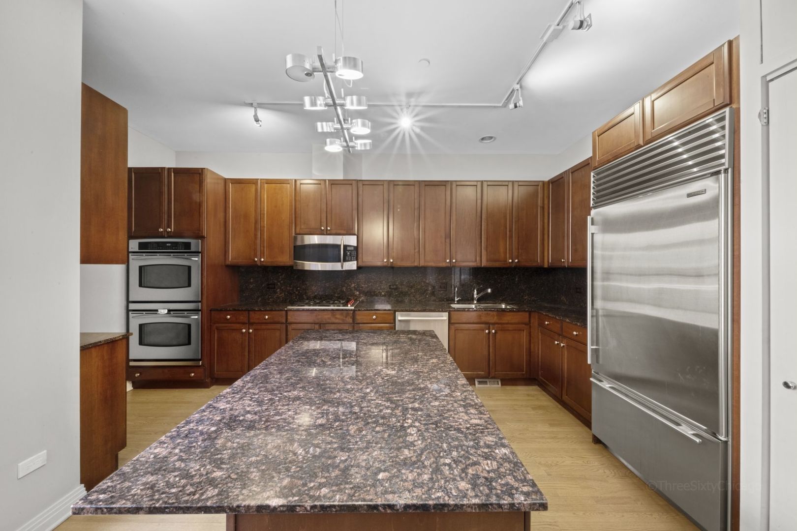 1137 West Monroe Street, Unit 17 Chicago, IL 60607 - Photo 10 of 41 a kitchen with stainless steel appliances granite countertop a refrigerator stove and oven