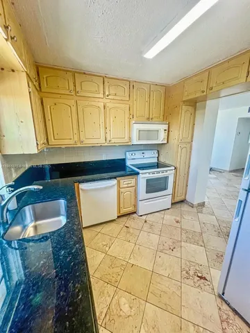 a kitchen with a sink and a stove