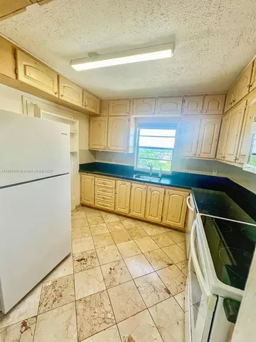 a view of a kitchen with a sink and dishwasher