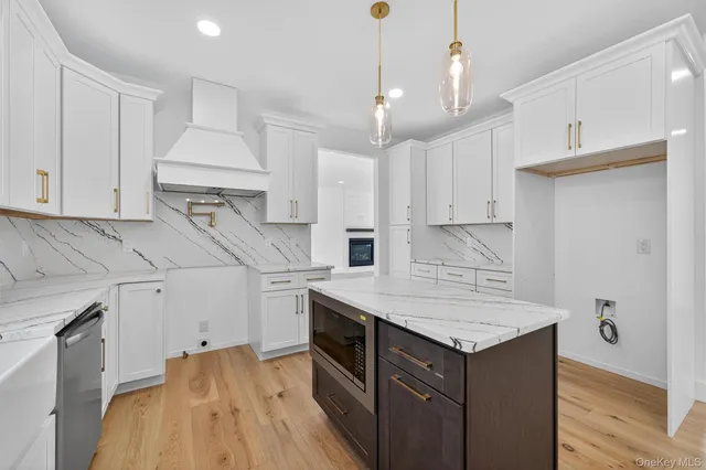a kitchen with a sink a stove and cabinets