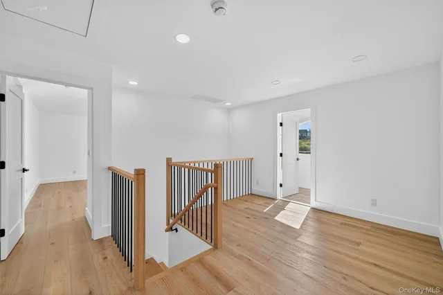 a view of a room with wooden floor and white walls