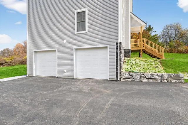 a view of a house with a yard and garage
