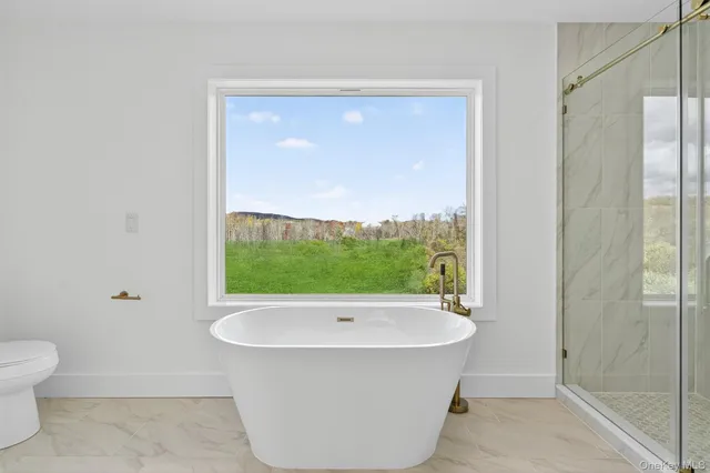 a bathroom with a bathtub and shower