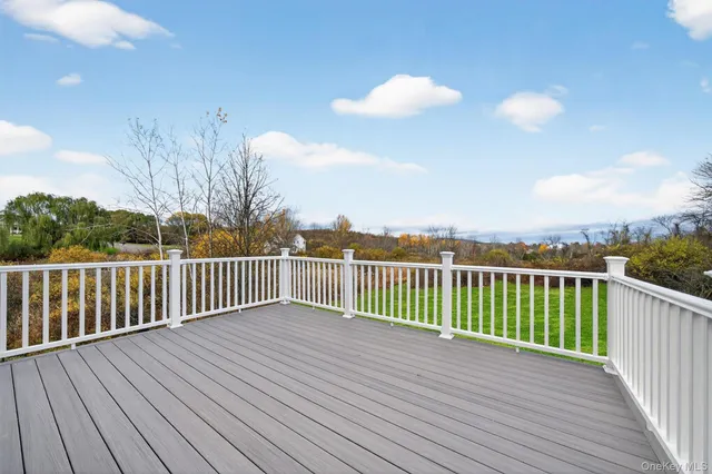 a view of a balcony with wooden floor