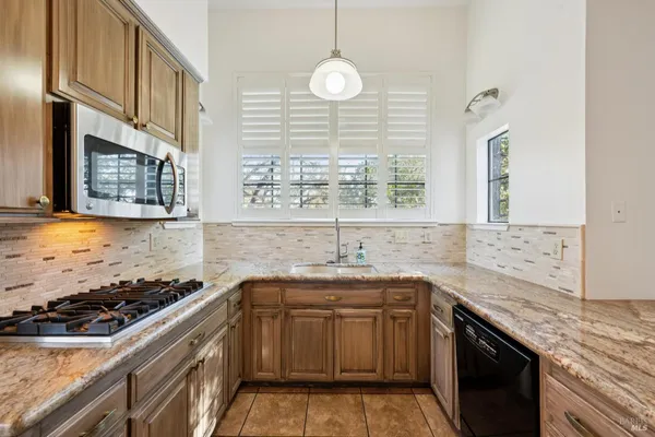 a kitchen with a sink stove and cabinets