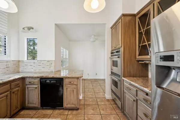a kitchen with stainless steel appliances granite countertop a sink and a stove