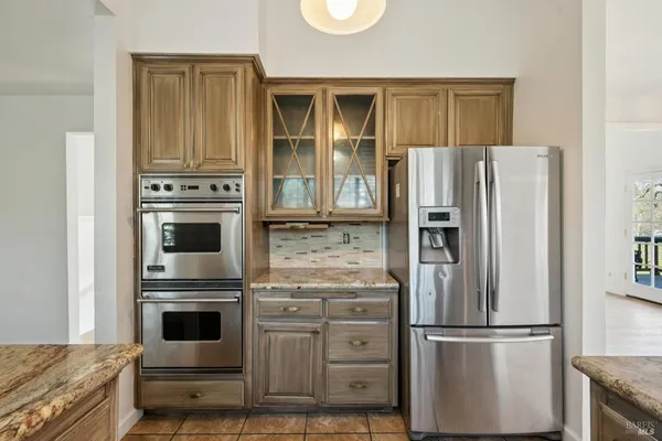 a kitchen with cabinets and stainless steel appliances