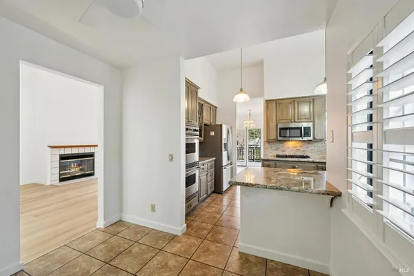a kitchen with stainless steel appliances a refrigerator and a stove top oven