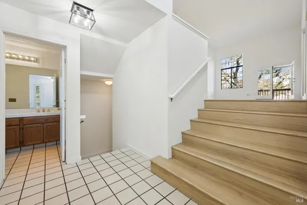 a view of entryway and hall with a bath tub