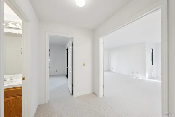 an empty room with windows and closet