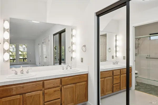 a bathroom with a granite countertop sink mirror and double