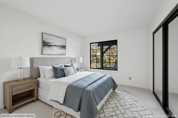 a bedroom with a bed and a window