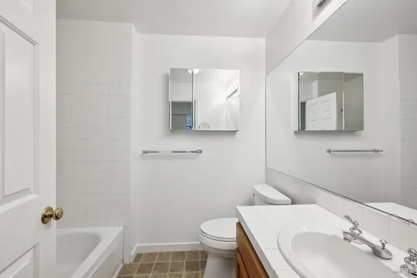 a bathroom with a sink toilet and tub
