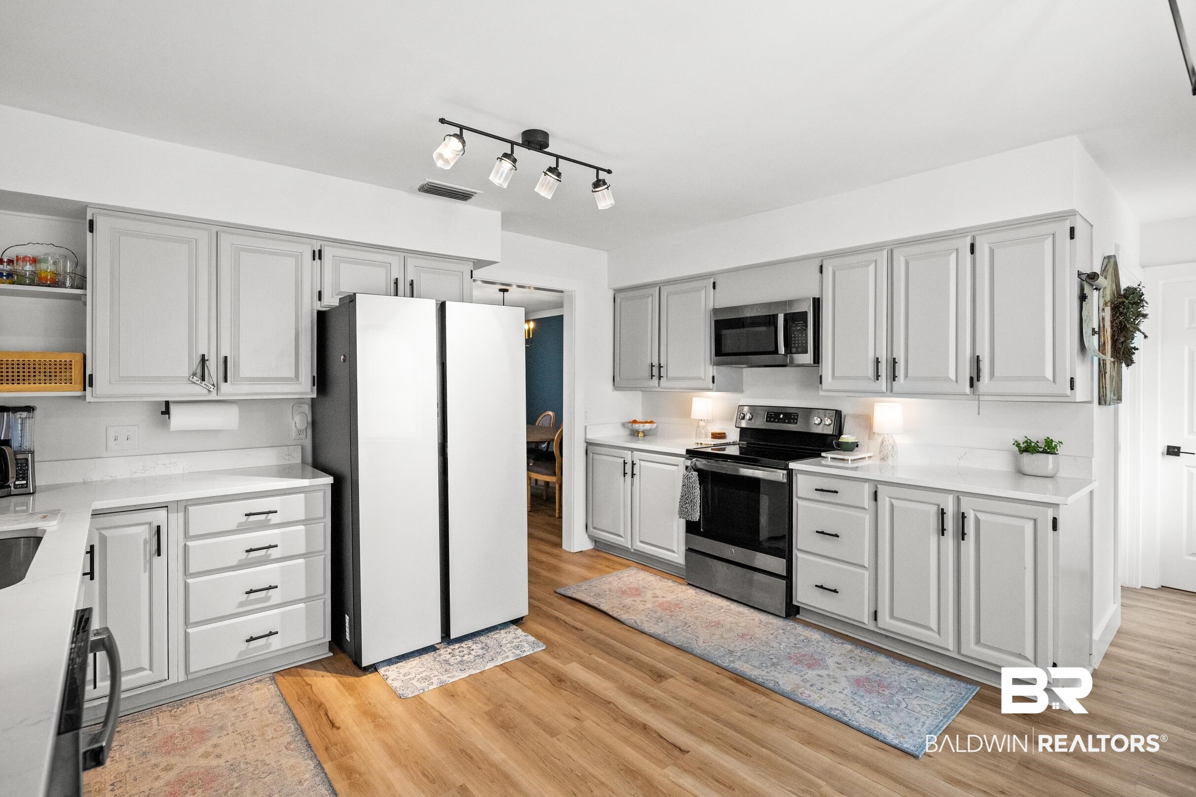6 Wren Circle Foley, AL 36535 - Photo 19 of 55 Kitchen featuring open shelves, light wood finished floors, light countertops, and appliances with stainless steel finishes