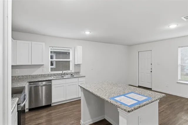 a kitchen with a sink cabinets and window