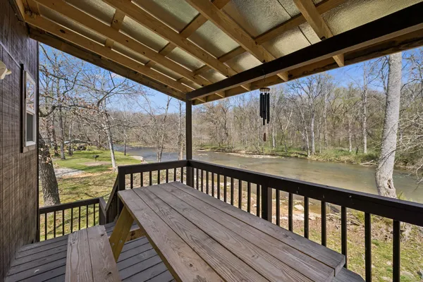 a backyard of a house with large trees and a yard