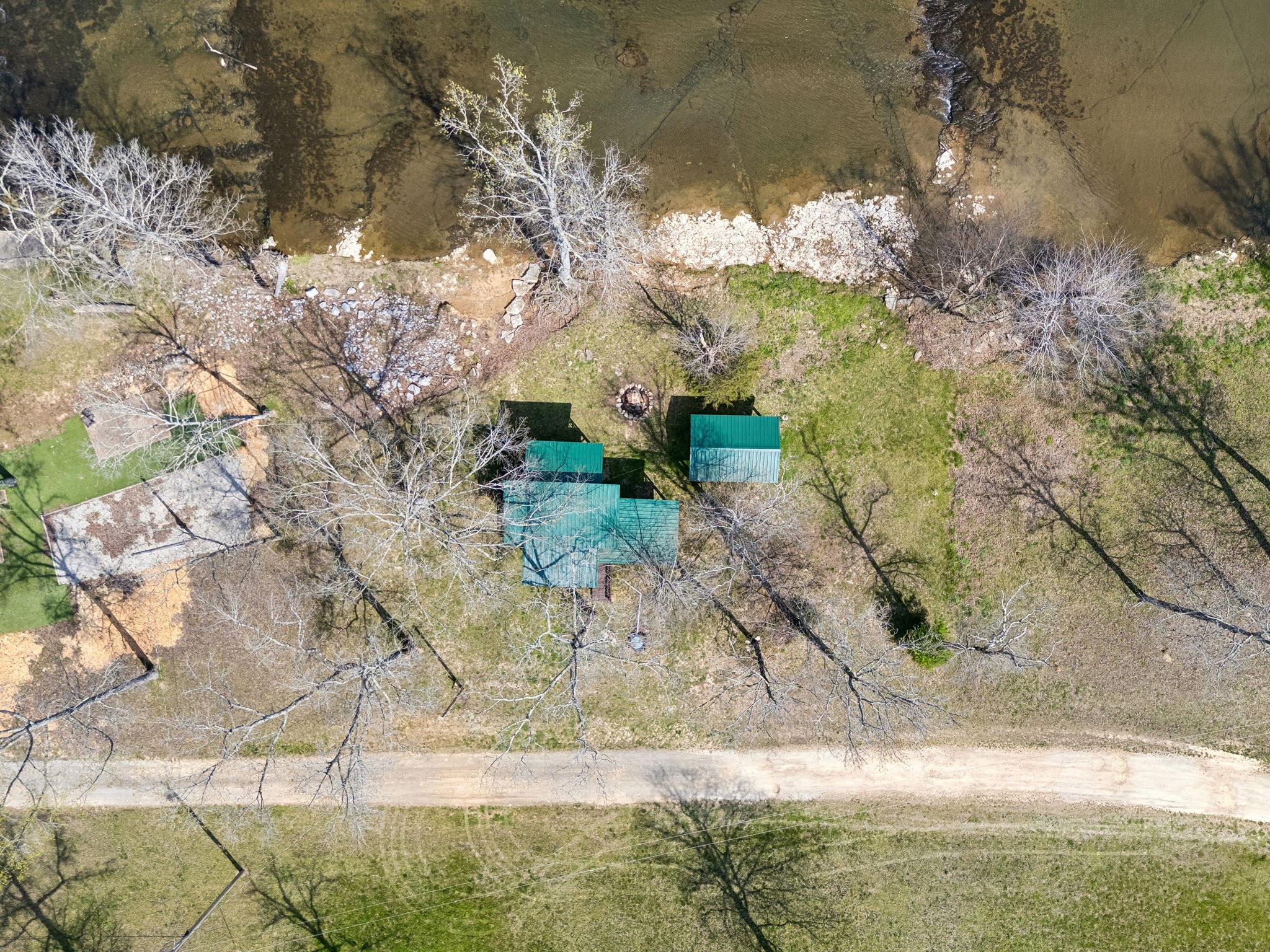506 Tablerock Road Hohenwald, TN 38462 - Photo 35 of 64 a backyard of a house with large trees and a yard