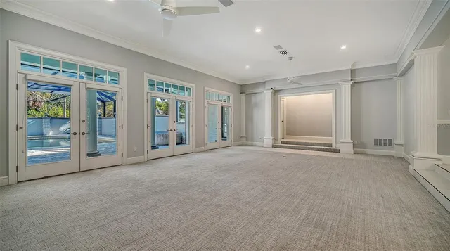 a living room with furniture a clock and a fireplace