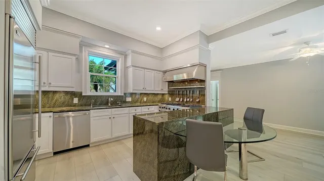 a bathroom with a granite countertop sink mirror and a bath tub