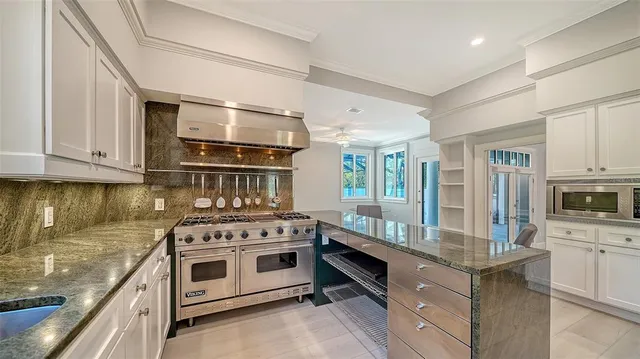 a bathroom with a granite countertop toilet and a shower