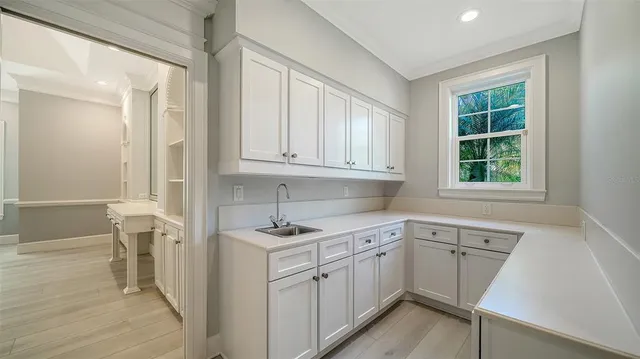 a bedroom with furniture and a large window