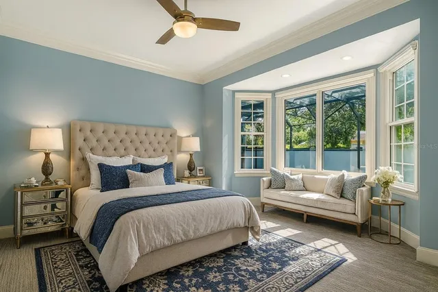 a living room with furniture and a floor to ceiling windows
