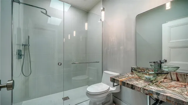 a front view of a house with a yard and palm trees