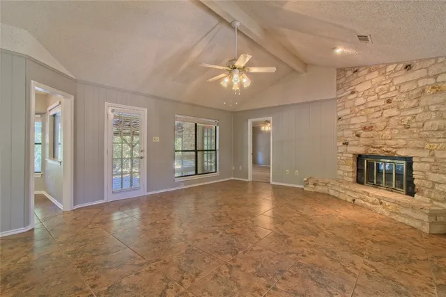 a view of an empty room with a fireplace
