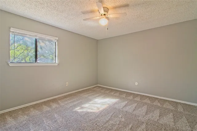 a bathroom with a granite countertop sink a toilet and bathtub