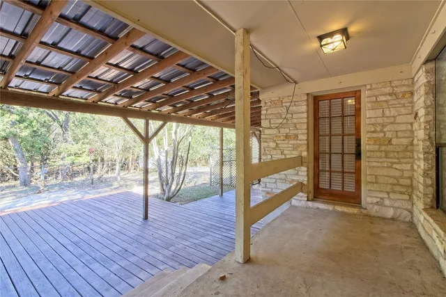a view of empty room with wooden floor and outdoor space