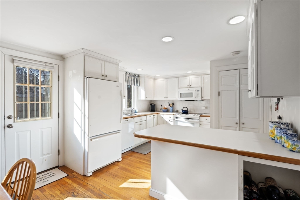 27 Cornell Road Marblehead, MA 01945 - Photo 12 of 34 a kitchen with refrigerator cabinets and a sink