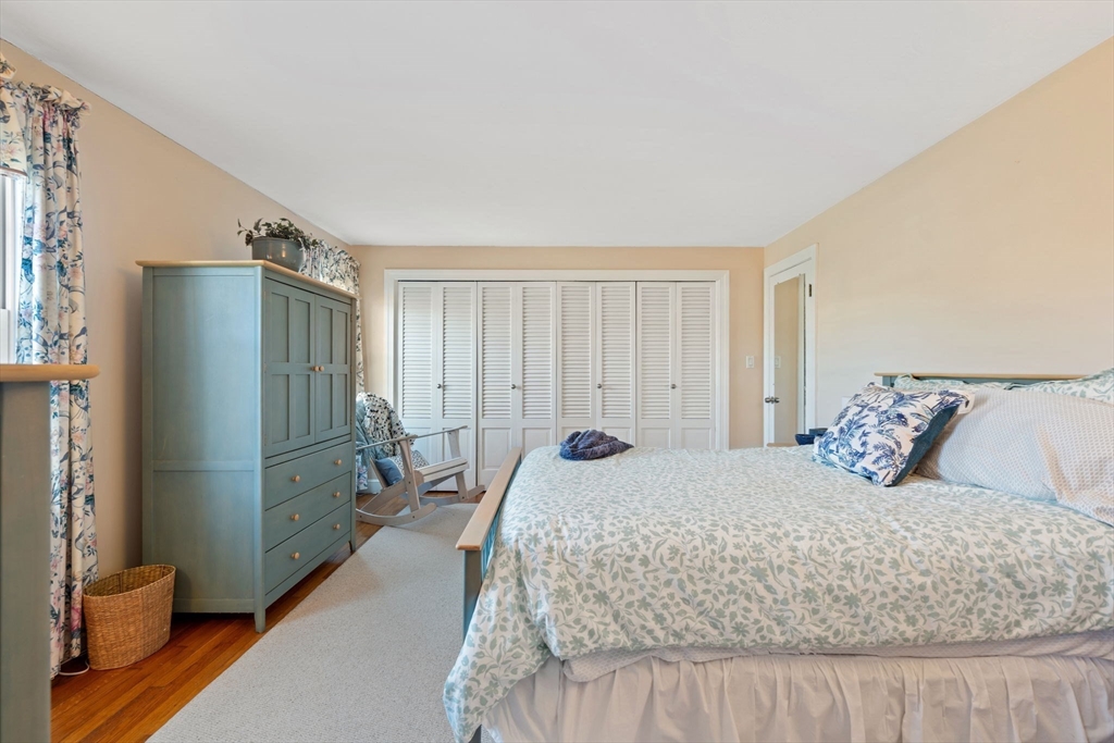 27 Cornell Road Marblehead, MA 01945 - Photo 18 of 34 a bedroom with a bed and a refrigerator