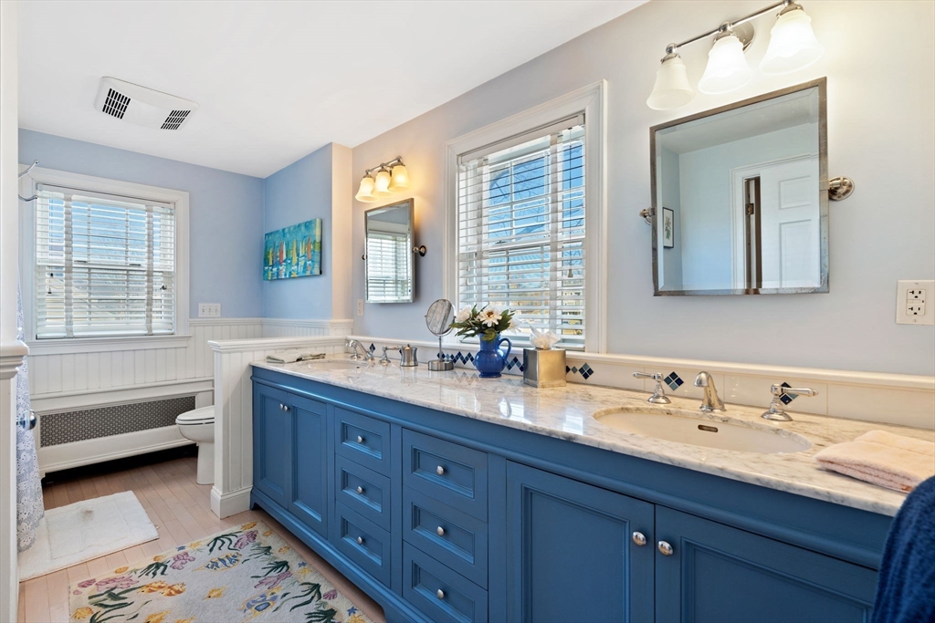 27 Cornell Road Marblehead, MA 01945 - Photo 19 of 34 a spacious bathroom with double vanity sink a two mirror a window a bathtub and vanity