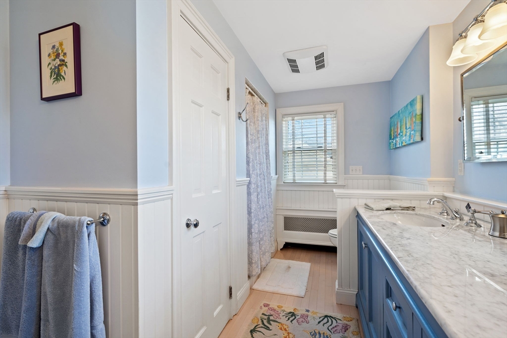 27 Cornell Road Marblehead, MA 01945 - Photo 20 of 34 a bathroom with a granite countertop sink a vanity and a bathtub
