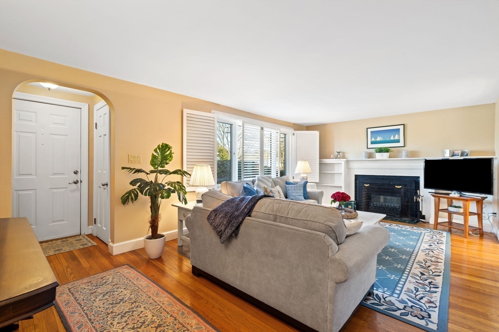 27 Cornell Road Marblehead, MA 01945 - Photo 5 of 34 a living room with furniture a large window and a fireplace