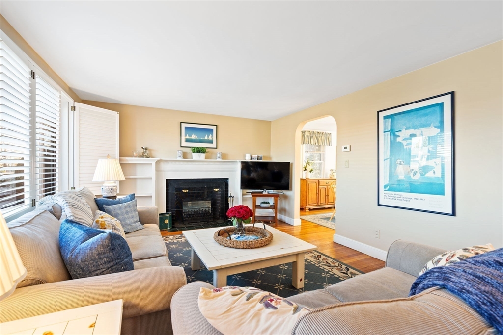27 Cornell Road Marblehead, MA 01945 - Photo 6 of 34 a living room with furniture flat screen tv and a fireplace