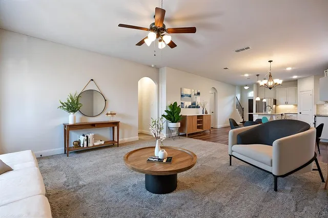 a living room with furniture and a chandelier