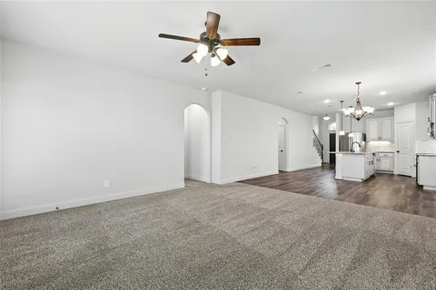 a view of a livingroom with a kitchen and chandelier