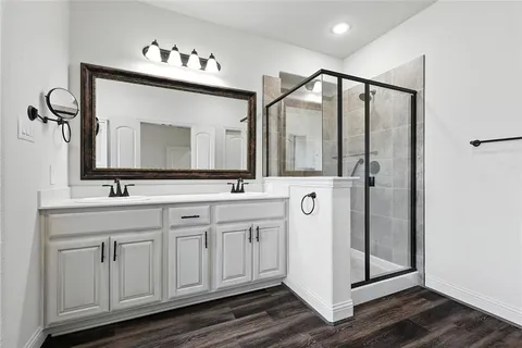 a bathroom with a double vanity sink and a mirror