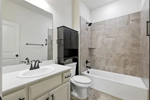 a bathroom with a sink a toilet and a bathtub