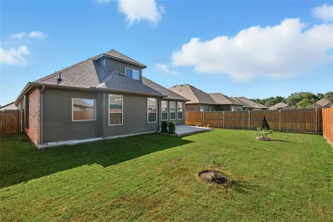 a backyard of a house with table and chairs