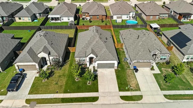 an aerial view of multiple houses with a yard