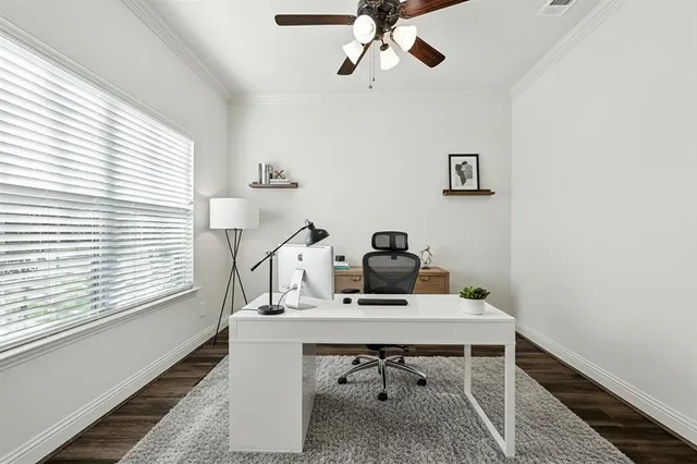a view of a workspace with furniture and a window