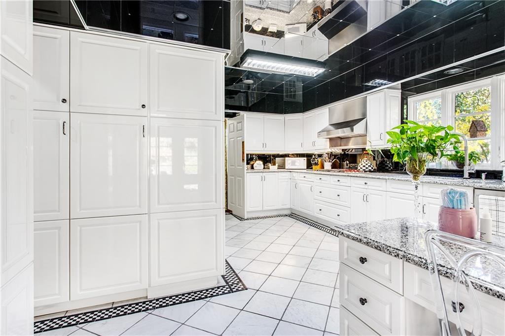 213 Hampton Road Pittsburgh, PA 15215 - Photo 12 of 21 a kitchen with white cabinets and appliances