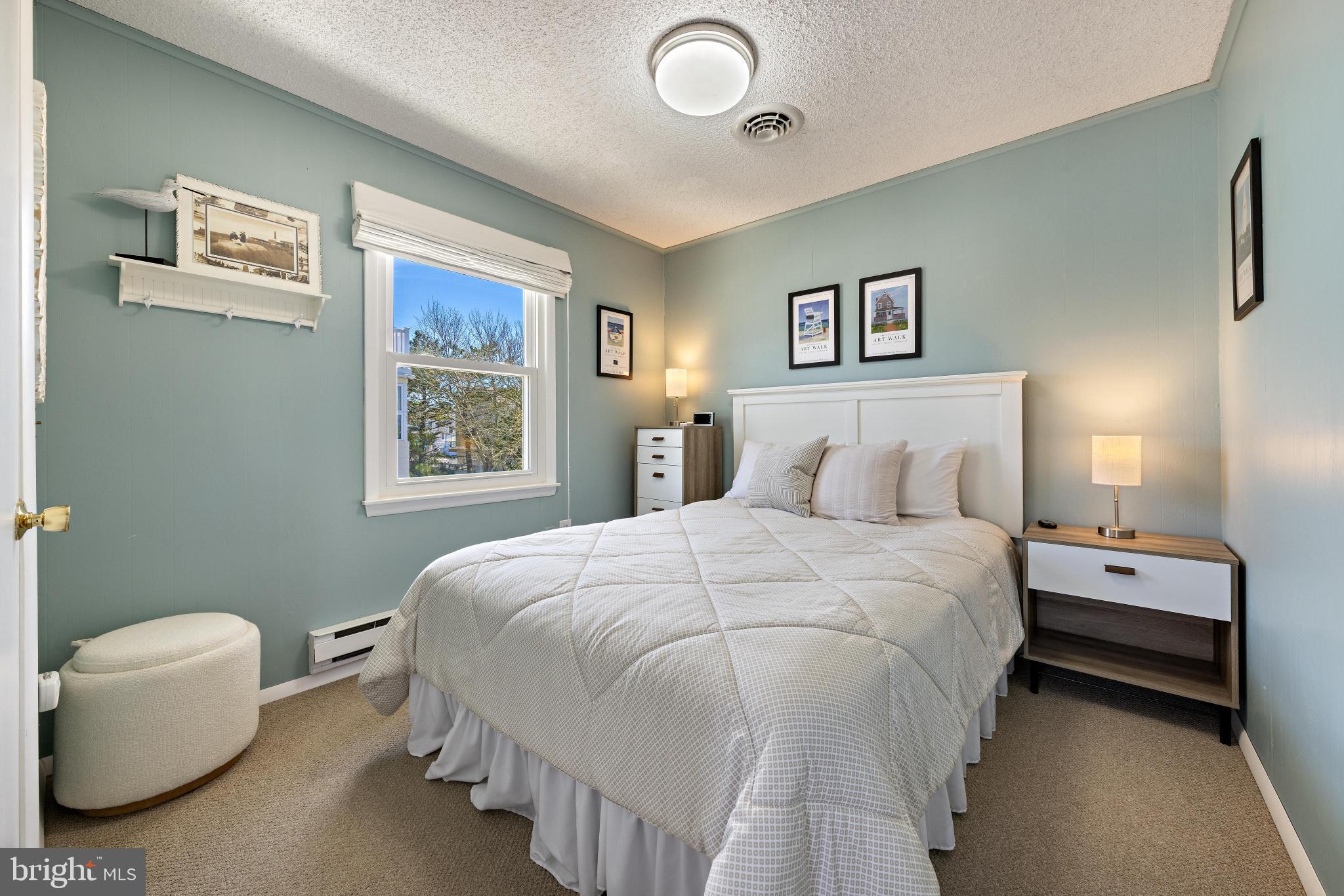 24 Joan Road Long Beach Township, NJ 08008 - Photo 14 of 55 a bedroom with a bed and a painting on the wall