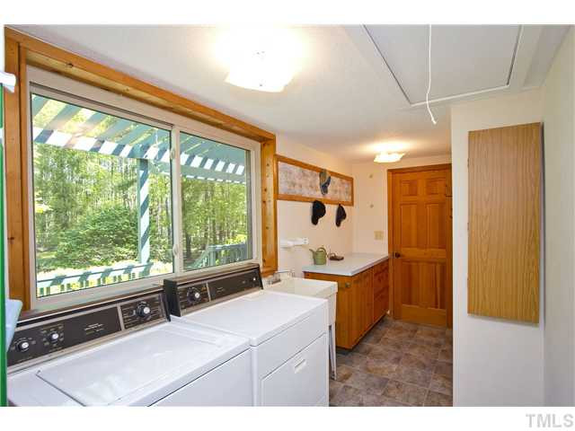 3729 Bosco Road New Hill, NC 27562 - Photo 11 of 25 Look at the size of this laundry room and the beatuiful tile flooring. There is a large soaking sink, nice area to fold the laundry and a built-in iron board. Another great view!!! Laundry Room
