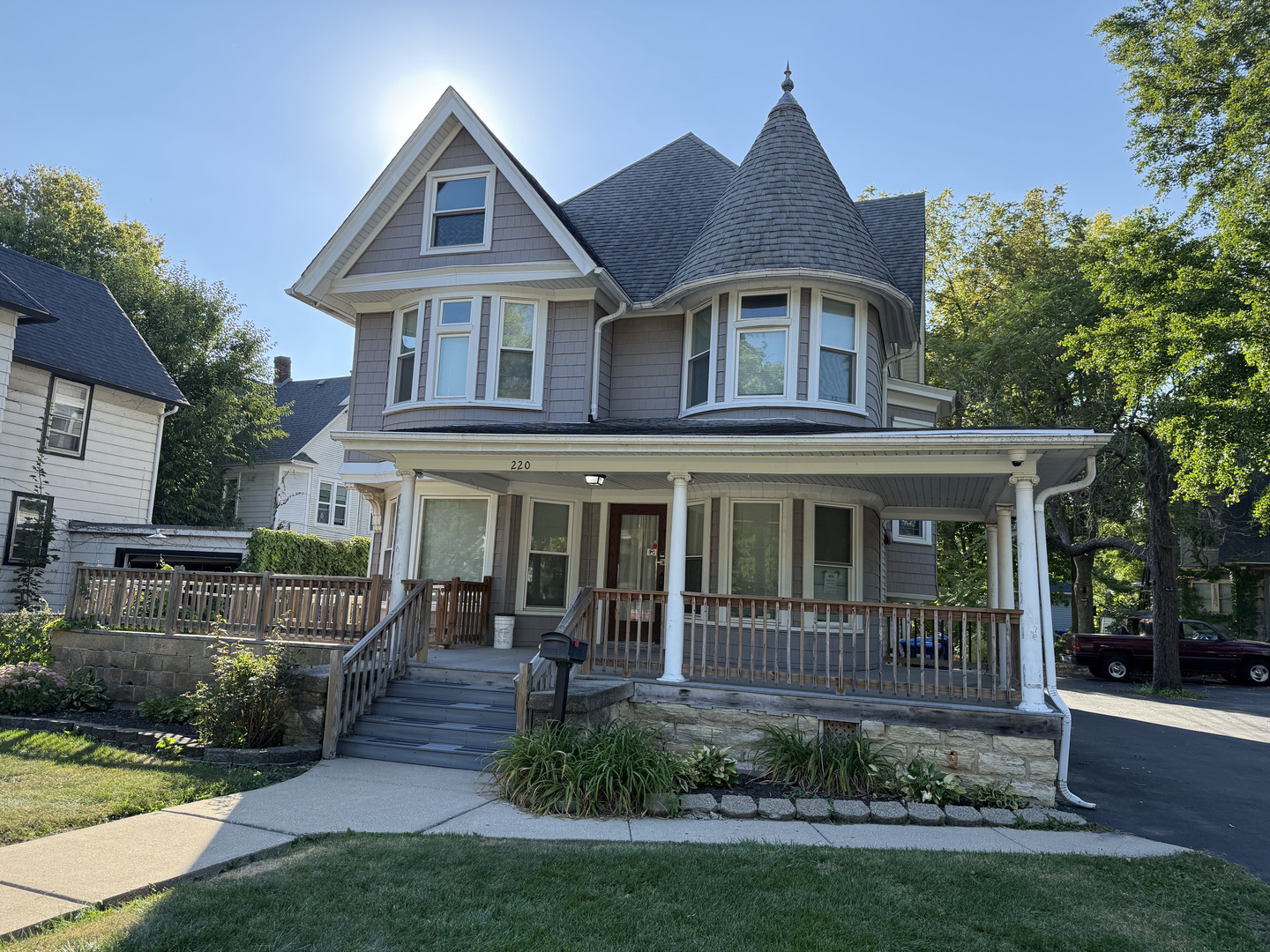 a view of a brick house with a yard and plants